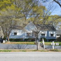 Single-story home with blue siding and white shutters.