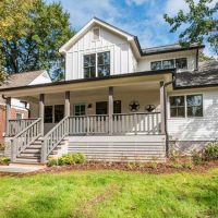 Traditional white farmhouse with front porch.