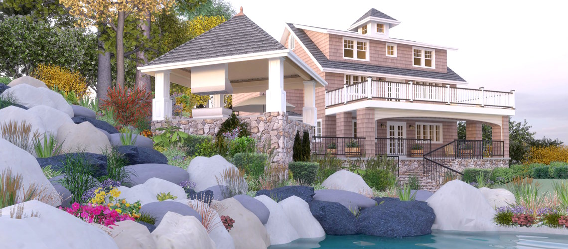 A coastal-style home with stone accents and a gazebo overlooks a landscaped hillside with large rocks and vibrant plants next to a serene body of water.