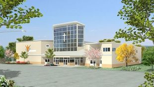 An image of a modern worship center with a tall glass atrium entry.