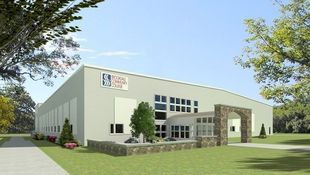 An example of a light commercial structure with a wide, low-slung gable roof and shallow overhangs.