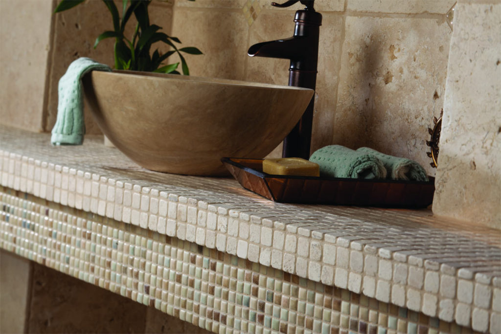 Bathroom counter with stone sink and counter top.