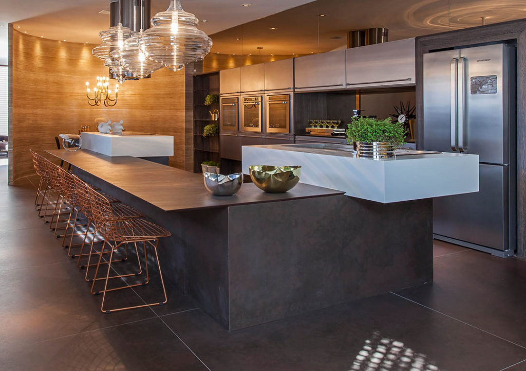 Large kitchen with stainless appliances and steel island.