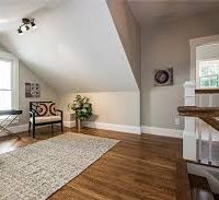 Landing area at the top of the stairs with a large window and sitting nook.
