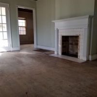 living room with large fireplace and plush carpet.