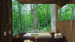 This Japanese inspired bath features a soaking tub elevated on a platform and open shower with teak flooring while opening to a lush scene of greenery with its full height seamless windows.